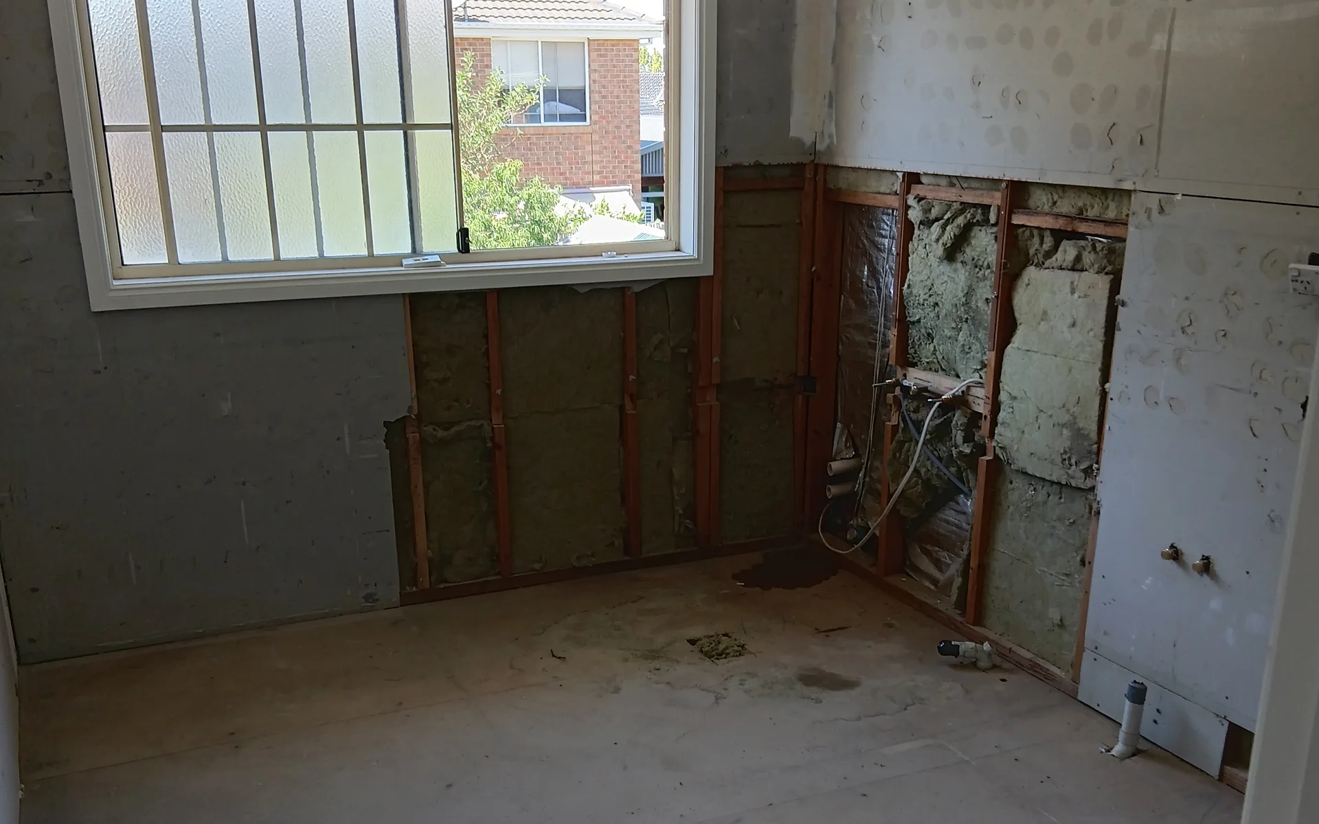 Bathroom opened up to expose damaged pipework in the wall and ceiling