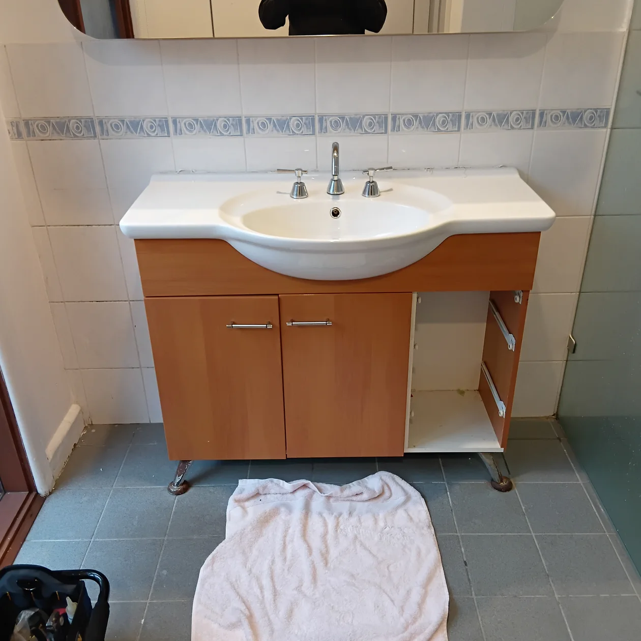 Old timber vanity being removed during a bathroom strip out